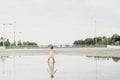 Little girl playing in a puddle, happy. stock photo