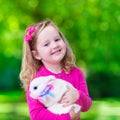 Little girl playing with rabbit Royalty Free Stock Photo