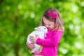 Little girl playing with rabbit Royalty Free Stock Photo