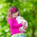 Little girl playing with rabbit Royalty Free Stock Photo