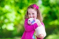 Little girl playing with rabbit Royalty Free Stock Photo