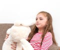 Little girl playing rabbit doll on the Sofa