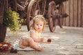 Little girl playing with rabbit in the village. Outdoor. Summer portrait. Royalty Free Stock Photo