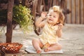 Little girl playing with rabbit in the village. Outdoor. Summer portrait. Royalty Free Stock Photo