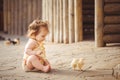 Little girl playing with rabbit in the village. Outdoor. Summer portrait. Royalty Free Stock Photo