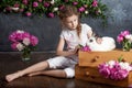 Little girl playing with real rabbit. Child and white bunny on Easter on flower background. Kids and pets play. Fun and friendship Royalty Free Stock Photo