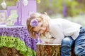 Little girl  play with real rabbit in the garden. Laughing child at Easter egg hunt with  pet bunny. Spring outdoor fun for kids Royalty Free Stock Photo