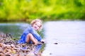 Little girl playing at river shore Royalty Free Stock Photo