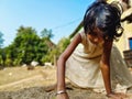 Little girl playing in the sand, close-up shot blue sky in the background Royalty Free Stock Photo