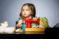 Little girl is playing with sewing machine Royalty Free Stock Photo