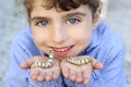 Little girl playing with silkworm in hands Royalty Free Stock Photo