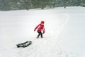 Little girl playing with sled in snow while snowflurry Royalty Free Stock Photo