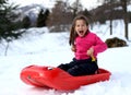 Little girl playing in the snow with the bob Royalty Free Stock Photo