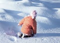 A little girl playing with snow outdoors at winter Royalty Free Stock Photo