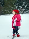 Little girl playing with snow while snowflurry Royalty Free Stock Photo