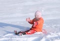 A little girl playing with snow in sunny winter day Royalty Free Stock Photo