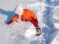 A little girl playing with snow in sunny winter day Royalty Free Stock Photo