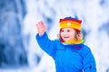 Little girl playing with snow in winter Royalty Free Stock Photo