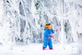Little girl playing with snow in winter Royalty Free Stock Photo