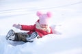 Little girl playing in snowdrift and having fun with fresh snow in park. Active outdoors leisure for kids on nature in snowy Royalty Free Stock Photo