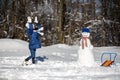 Little girl playing with a snowman Royalty Free Stock Photo