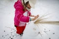 Little girl playing with snowman Royalty Free Stock Photo