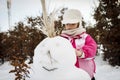 Little girl playing with snowman Royalty Free Stock Photo