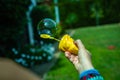 Little girl playing soap bubbles in the backyard in the sun Royalty Free Stock Photo