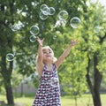 Little girl playing with soap bubbles Royalty Free Stock Photo