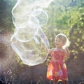 Little girl playing with soap bubbles Royalty Free Stock Photo