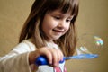 Little Girl Playing Soap Bubbles at home Royalty Free Stock Photo