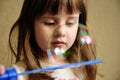 Little Girl Playing Soap Bubbles at home Royalty Free Stock Photo
