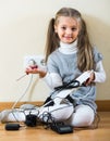 Little girl playing with sockets at home Royalty Free Stock Photo