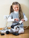 Little girl playing with sockets at home Royalty Free Stock Photo