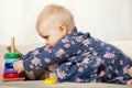 Little girl playing with stalking toy pyramid Royalty Free Stock Photo