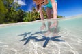 Little girl playing with starfish Royalty Free Stock Photo