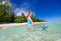 Little girl playing with starfish Royalty Free Stock Photo