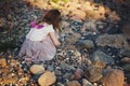 Little girl playing on stones beach Royalty Free Stock Photo