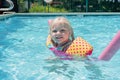 Little girl playing at the pool on a summer day Royalty Free Stock Photo