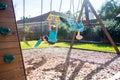 Little girl playing on swing-set in the backyard on a sunny day Royalty Free Stock Photo