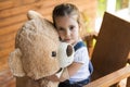 Little girl playing with teddy bear