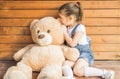 Little girl playing with teddy bear Royalty Free Stock Photo