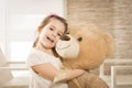 Little girl playing with teddy bear