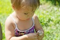 Little girl playing with toxic toadstool mushrooms Royalty Free Stock Photo