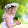 Little girl playing with a toy duck Royalty Free Stock Photo