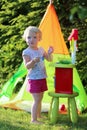 Little girl playing with toy kitchen outdoors Royalty Free Stock Photo