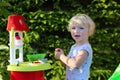 Little girl playing with toy kitchen outdoors Royalty Free Stock Photo