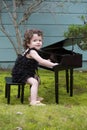 Little girl playing on toy piano Royalty Free Stock Photo