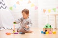 Little girl is playing with toy pyramid at home Royalty Free Stock Photo