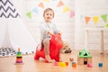 Little girl playing with toy red horse at home Royalty Free Stock Photo